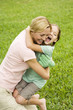 mother and daughter hugging in the garden
