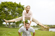 mid adult couple playing leapfrog