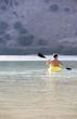 A man canoeing on a lake