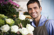 Male florist amongst the flowers in his shop