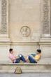 Couple on bench smiling at each other, side view