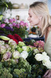 Woman choosing flowers in a florist's shop