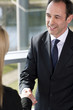 Businessman shaking hands with female client or colleague