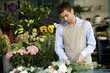 Male florist creating a bouquet of flowers