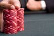 Woman with hand on pile of gambling chips, close-up