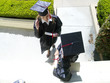 Female graduates in conversation, in caps and gowns, elevated view