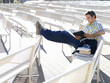 Male student on bench reading
