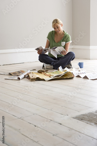 Photo: Woman decorating, looking at colour swatches Woman decorating, looking at colour swatches
