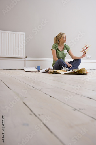Photo: Woman with colour swatches, low angle view Woman with colour swatches, low angle view
