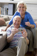 Senior couple with camera, smiling, portrait