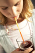 A teenage girl drinking.