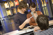 A couple buying movie tickets at the box office.