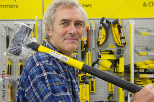 Photo: Man with sledge hammer in hardware store, portrait Man with sledge hammer in hardware store, portrait