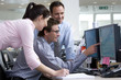 Businessman showing colleagues graph on monitor
