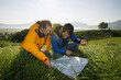 A couple using a map and a compass to find directions.
