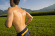 Photo: A man running in a field. A man running in a field.