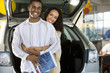 Couple shopping for cars in showroom