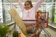 Young girl grocery shopping in frozen foods section
