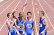 Group of male athletes with arms raised in celebration, elevated view