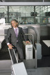 A man checking in his luggage at the airport.
