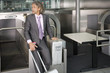 A man checking in his luggage at the airport.