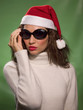 Woman wearing a Christmas hat and sunglasses.