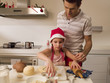 Father baking cookies with his daughter.