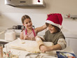 Brother and sister baking cookies.