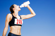Photo: Portrait of a female athlete drinking form a water bottle Portrait of a female athlete drinking form a water bottle