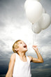 A young boy with a bunch of balloons