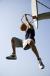 Foto: Portrait of young African jumping and hanging from a basketball ring Portrait of young African jumping and hanging from a basketball ring