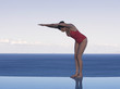 A woman preparing to dive into a pool