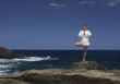A woman meditating by the sea