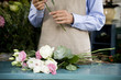 Male florist creating a bouquet of flowers