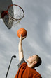 A teenage boy playing basketball