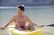 A man canoeing on a lake
