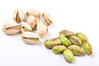 Several pistachio nuts naked and in shell close up isolated