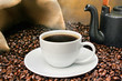 Freshly brewed coffee over dark roasted coffee beans
