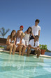 Family sitting by the pool.