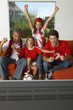 Family watching a sports match on TV.