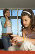 Sisters using their cell phones.