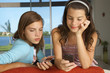 Sisters using their cell phones.