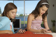 Sisters using their cell phones.