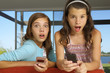 Sisters using their cell phones.