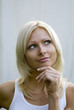 young blond woman thinking