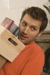 Close-up of a young man carrying a crate