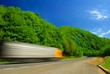 Heavy truck on the road. Motion blur. Deep blue sky