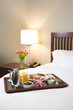 Breakfast tray on white bed.