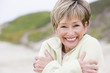 Photo: Woman at the beach cold and smiling Woman at the beach cold and smiling