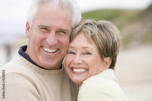 Photo: Couple at the beach smiling Couple at the beach smiling
